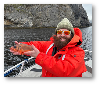 Tyler Beech holding a redfish during fieldwork